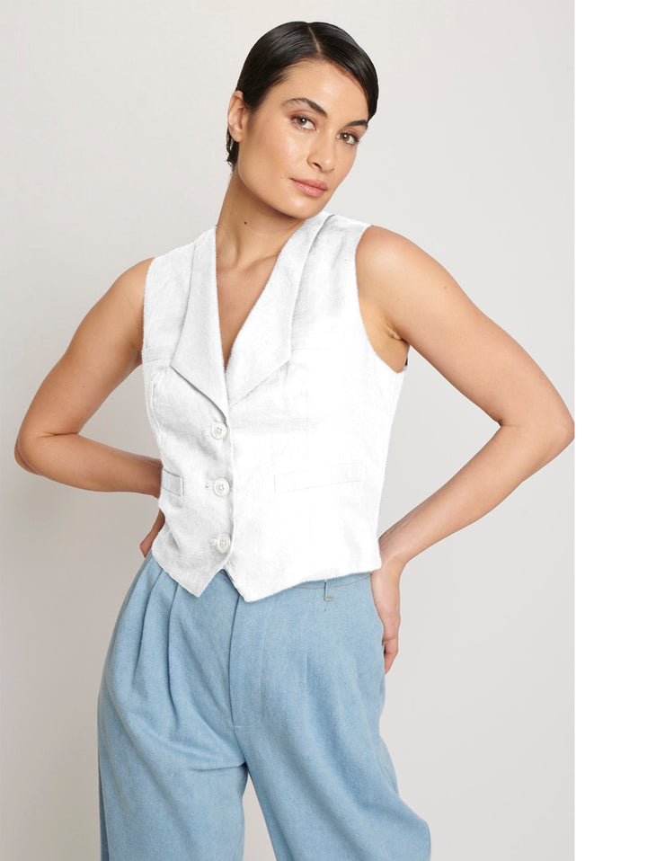 White denim vest with lapel , three button closure and adjustable D-ring waist tab, functional pockets and light blue cotton denim pleated pants 