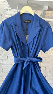 Navy blue 100% french linen jumpsuit with wide flowing legs, pleated bust, lapel, adjustable sleeve length, matching fabric tie belt.