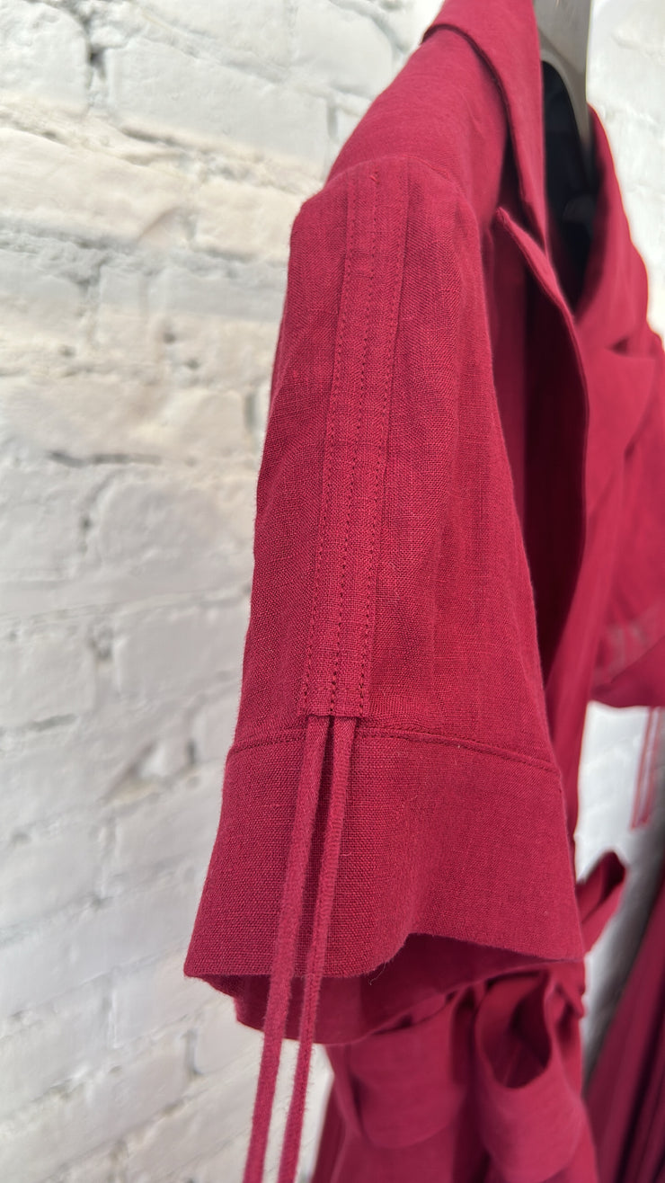 red 100% french linen jumpsuit with wide flowing legs, pleated bust, lapel, adjustable sleeve length, matching fabric tie belt.