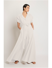 White linen wide leg jumpsuit with lapel and matching fabric belt